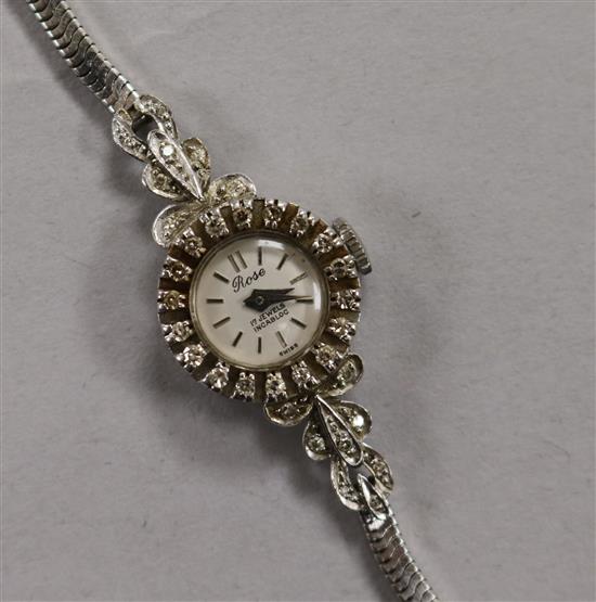 A ladys 18ct white gold and diamond set Rose cocktail watch, on a 9ct white gold snakelink bracelet.